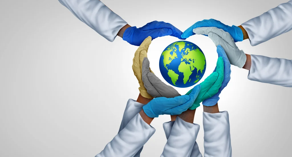 Hands in different colors and gloves form a heart shape around a globe, symbolizing global unity and environmental care.