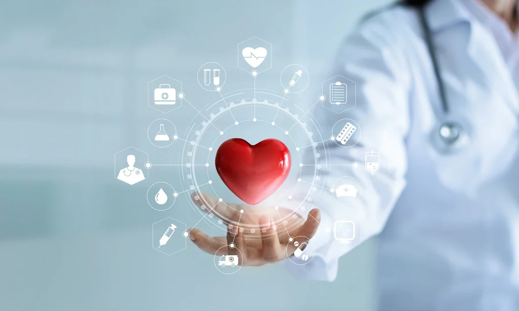 A healthcare professional in a white coat holds a glowing red heart symbol, surrounded by medical icons and data graphics.