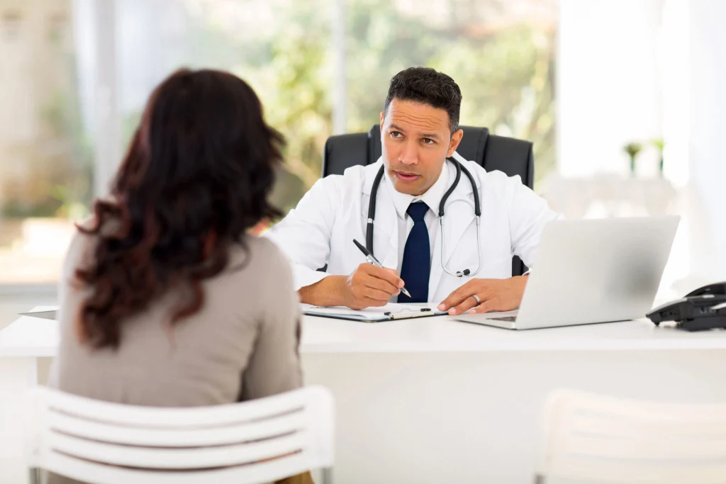 Doctor in a white coat consulting a patient, demonstrating heart-smart moving tips for maintaining cardiovascular health during relocation.